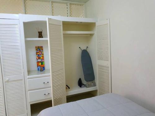 a bedroom with white closets and a bed at 1-bedroom suburban apartment with free parking in Kingstown