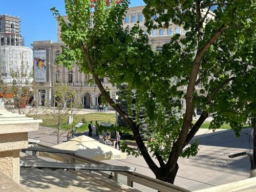 a building with a tree in front of it at Skopje Plaza Apartment in Skopje