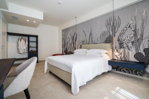 a bedroom with a bed and a wall mural at I Due Mori - Luxury Rooms in Giardini Naxos