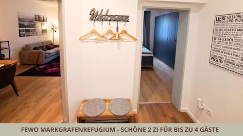 a living room with a wall with shoes on display at FeWo Markgrafenrefugium zentrumsnahe 2 Zi mit Küche für 1-4 Personen in Bayreuth