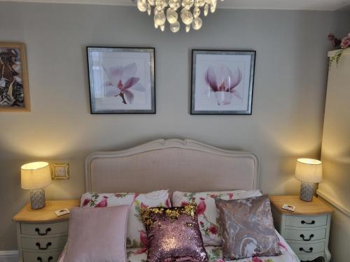 a bedroom with a bed with two night stands and two lamps at Tiffy's Place in Blackpool
