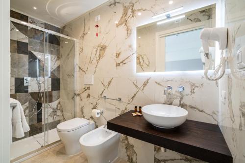 a bathroom with a sink and a toilet and a shower at I Due Mori - Luxury Rooms in Giardini Naxos