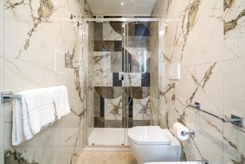 a bathroom with a toilet and a shower at I Due Mori - Luxury Rooms in Giardini Naxos