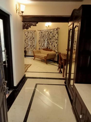 a living room with a couch and a mirror at Juna Mahal Jungle Resort Ranthambore in Sawāi Mādhopur