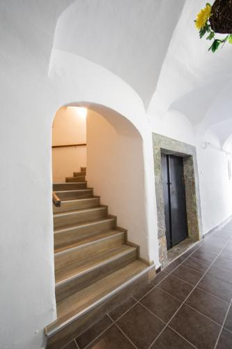 a staircase in a house with a white wall at Ubytování v centru in Lanškroun