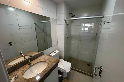 a bathroom with a sink and a glass shower at Hosts BR-Flat Fit Transamérica Boa Viagem s/ taxa in Recife