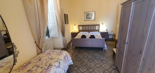 a small bedroom with two beds and a window at B&B Maricentro in Taranto