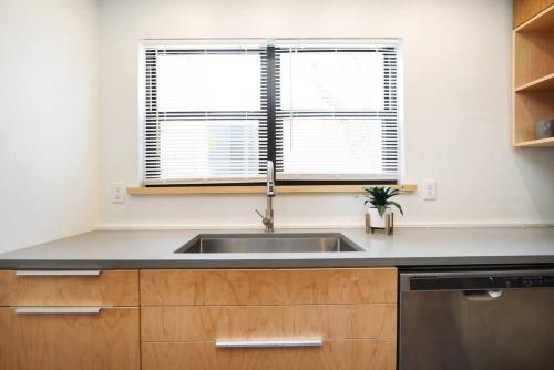 a kitchen with a sink and a window at Elegant 2BR Escape in Manhattan with WiFi & Parking in Manhattan