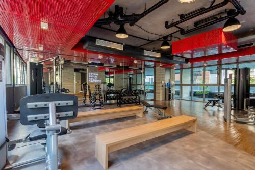 a gym with benches in a room with red ceilings at BHomy Oscar Freire 2 in Sao Paulo