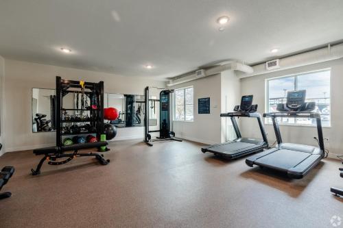 a gym with several treadmills and machines in a room at WaterWalk Extended Stay by Wyndham Wichita in Wichita
