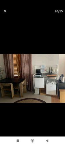 a living room with a table and a kitchen at B&B Villa Alma in San Costanzo