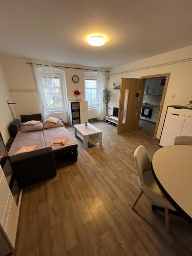 a bedroom with a bed and a living room at ApartmentsCarlsbad in Karlovy Vary