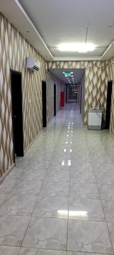 a hallway of a building with a tile floor at BABYLOON بابيلون in Salalah