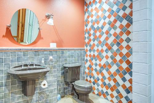 a bathroom with a toilet and a mirror at Family Home with Indoor Pool about 2 Mi to Elkhart Lake! in Elkhart Lake