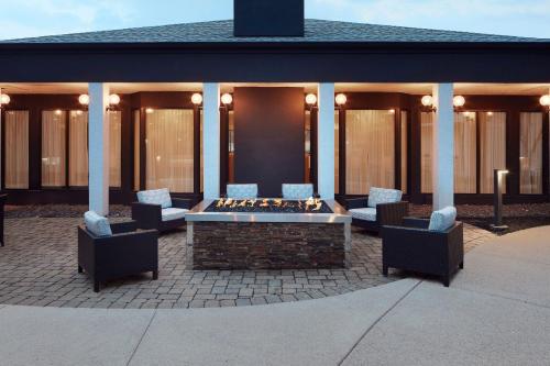 a patio with chairs and a fire pit in front of a building at Courtyard Columbus Dublin in Dublin