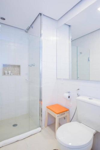 a bathroom with a toilet and a glass shower at BHomy Madison in Sao Paulo
