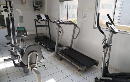 a gym with several cardio machines in a room at BHomy Madison in Sao Paulo