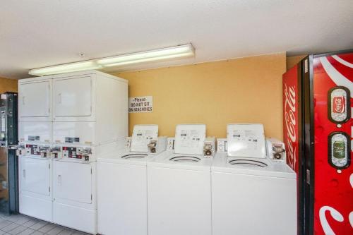 a row of washers and dryers in a room at Camelot By The Sea - Blue Palmetto Vacation Rentals in Myrtle Beach