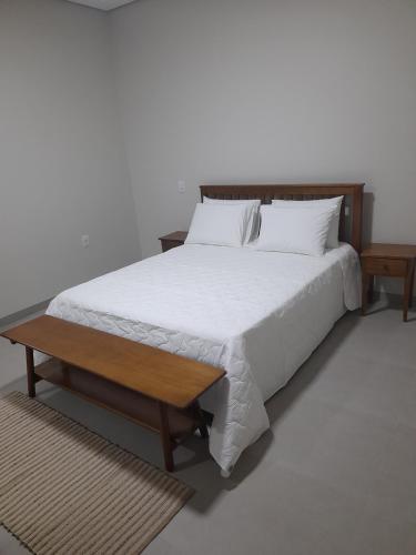a bedroom with a large bed with a wooden headboard at Hotel Pimenta in Pimenta Bueno