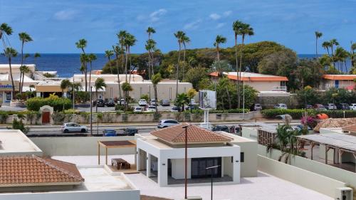 a view of a city with palm trees and the ocean at Villa Monrel Mambo Beach in Willemstad