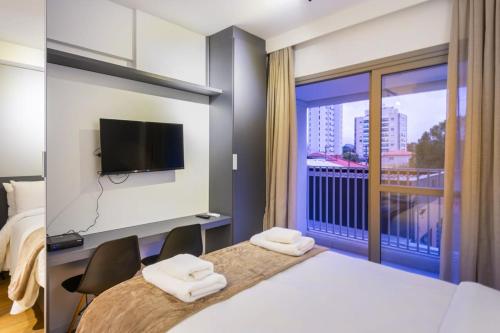 a hotel room with a bed and a large window at BHomy Brooklin - Com varanda espaçosa BUR205 in Sao Paulo