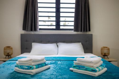 Säng eller sängar i ett rum på Villa Monrel Mambo Beach