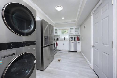a laundry room with a washer and dryer at New! Comfy Home with Playground Near Ft Moore! in Columbus