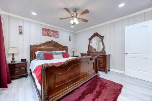 a bedroom with a bed and a ceiling fan at New! Comfy Home with Playground Near Ft Moore! in Columbus