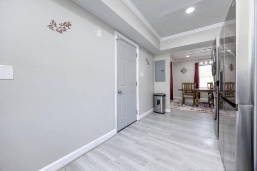 a white hallway with a kitchen and a dining room at New! Comfy Home with Playground Near Ft Moore! in Columbus