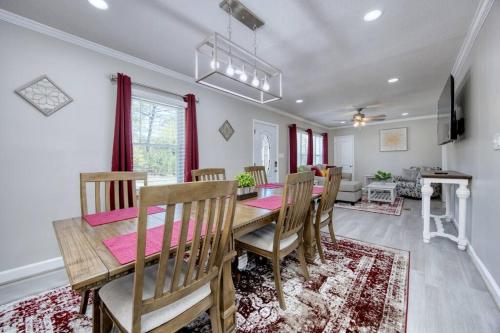 a dining room with a wooden table and chairs at New! Comfy Home with Playground Near Ft Moore! in Columbus