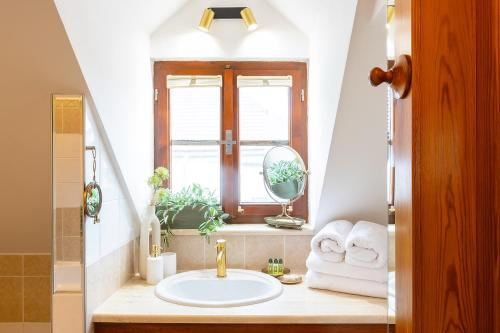a bathroom with a sink and a window at Wellness Pension Ametyst in Český Krumlov