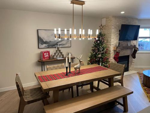 a dining room with a table and a christmas tree at Ski In-Out Hot Tub Gym Sauna Pool Reserved Parking-503 in Brighton