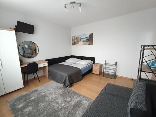 a bedroom with a bed and a desk and a ladder at Pokoje AGA in Mikołajki