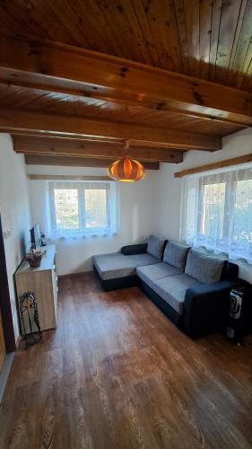 a living room with a couch and a table at Chata v Moravském krasu in Sloup