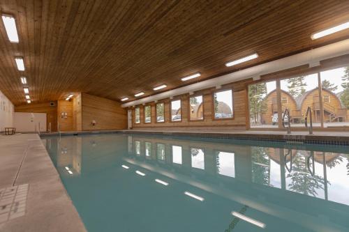 a large swimming pool in a large building at Ocean Village Resort in Tofino