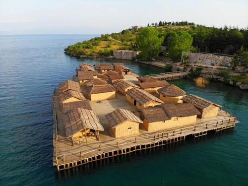 an island with a bunch of houses on the water at Villa Lakeview Paradise in Peštani