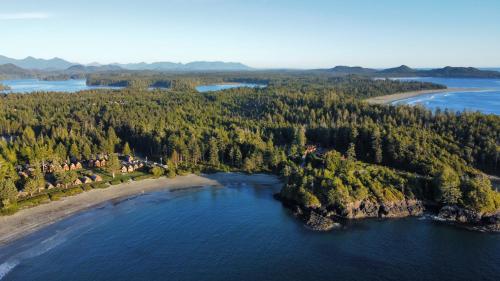 an island in the water next to a beach at Ocean Village Resort in Tofino