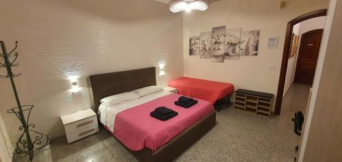 a small bedroom with two beds and a lamp at B&B Del Maresciallo in Leporano