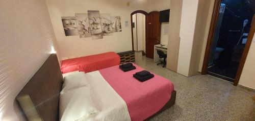a small bedroom with two beds and a desk at B&B Del Maresciallo in Leporano