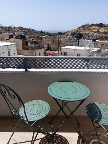 a balcony with two chairs and a table at Villa katina in Pitsidia