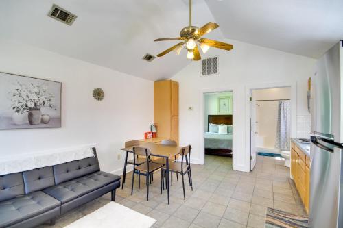 a kitchen and living room with a couch and a table at Biloxi Resort Cottage with Pool and Lake Access! in Biloxi