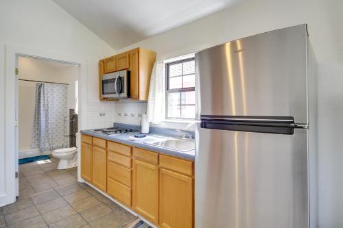 a kitchen with a stainless steel refrigerator and a sink at Biloxi Resort Cottage with Pool and Lake Access! in Biloxi