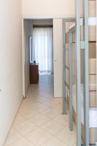 a corridor of a room with a staircase and a bedroom at Τοτα Μαρινου in Trikovilón