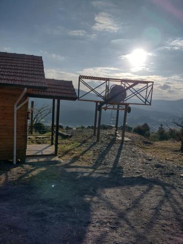 a metal structure sitting on the side of a house at HOSPEDAGEM CK in Urubici