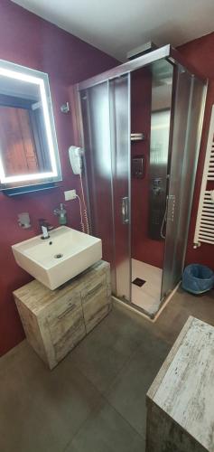 a bathroom with a white sink and a shower at B&B Del Maresciallo in Leporano