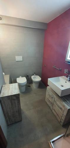 a bathroom with a toilet and a bidet and a sink at B&B Del Maresciallo in Leporano