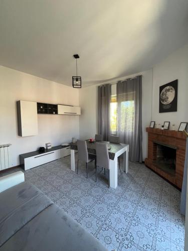 a living room with a bed and a dining room at Reversal apartment in Santa Marinella