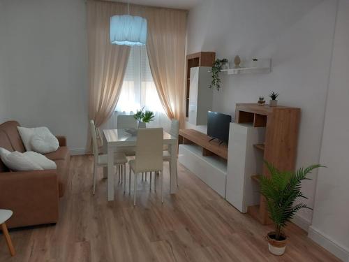 a living room with a table and a dining room at La dolce vita casa vacanze in Cisterna di Latina
