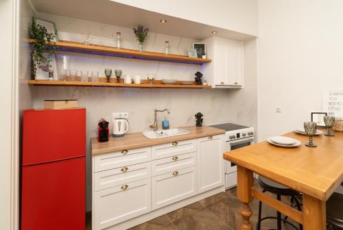 a kitchen with a red refrigerator and a table at villa Chris in Pylos