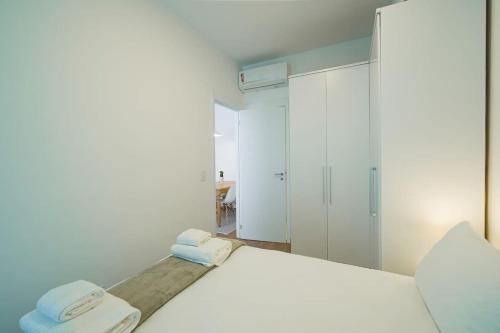 a bedroom with a white bed with two towels at BHomy Brooklin Perto Morumbi Shopping PSP2710 in Sao Paulo